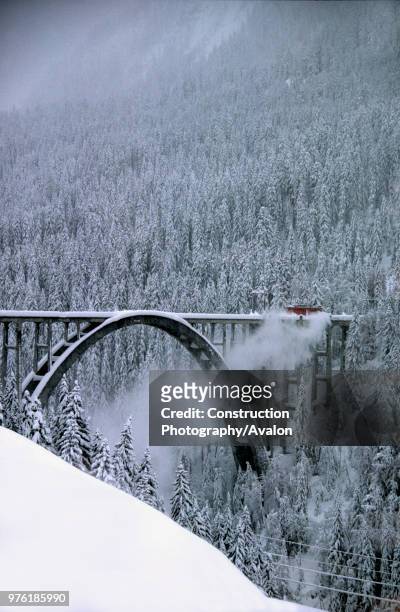 Snowplough locomotive of Rhaetian railway crossing Langwieser viaduct, Swiss Alps, Canton of Grisons, Switzerland.