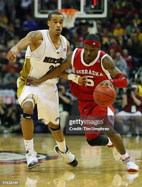 Guard Sek Henry of the Nebraska Cornhuskers sprints up the court while defended by forward Laurence Bowers of the Missouri Tigers at the Sprint...