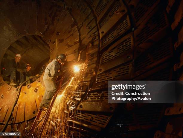 Repairing ball mill in copper mine, Canada.