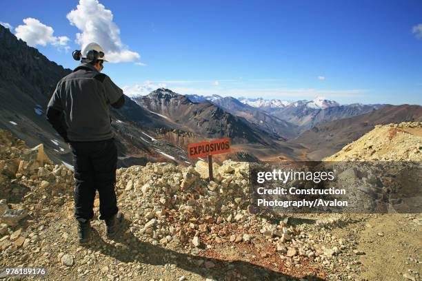 Geologist Next To Explosive Sign In The Andes Looks To Argentina, At 4000 m High They have The Best View To Argentina.