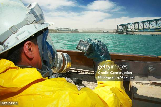 Inspector Measuring Sulphuric Acid Flotation Tanks.