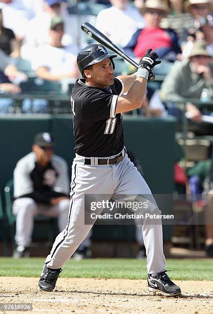 Omar Vizquel of the Chicago White Sox bats against the Oakland Athletics during the MLB spring training game at Phoenix Municipal Stadium on March...