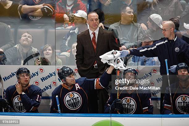 Assistant coach Kelly Buchberger, Shawn Horcoff, Robert Nilsson and Andrew Cogliano of the Edmonton Oilers rest on the bench against the Minnesota...