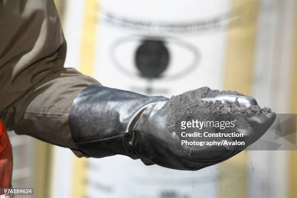 Man holding Molybdenite with Security Gloves in Chuquicamata, a mineral occurring in soft, lead-gray, foliated masses or scales, resembling graphite;...