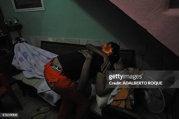 Cuban opposition activist Guillermo Farinas is hugged by a relative at his home in Santa Clara, Cuba, March 10, 2010. Farina, who has been in hunger...