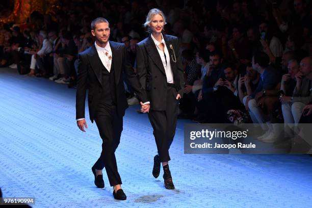 Adam Senn and Adriana Cernanova walk the runway at the Dolce & Gabbana show during Milan Men's Fashion Week Spring/Summer 2019 on June 16, 2018 in...