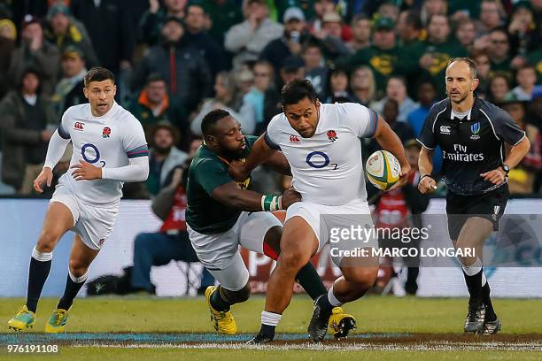 England's prop Mako Vunipola is tackled by South Africa's prop Tendai Mtawarira during the second test match South Africa vs England at the Free...