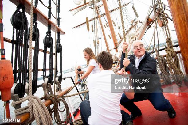 In this handout photo provided by the German Government Press Office , German President Frank-Walter Steinmeier helps hoist a sail on the ship 'Thor...