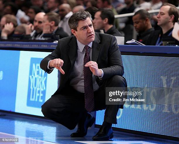 Head coach Keno Davis of the Providence Friars looks on from the bench against the Seton Hall Pirates during the first round game of the Big East...