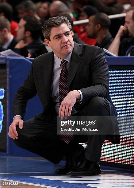 Head coach Keno Davis of the Providence Friars looks on from the bench against the Seton Hall Pirates during the first round game of the Big East...