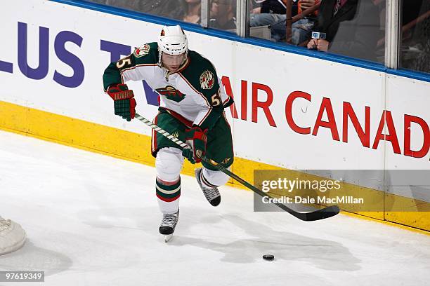 Nick Schultz of the Minnesota Wild handles the puck against the Edmonton Oilers on March 5, 2010 at Rexall Place in Edmonton, Alberta, Canada.