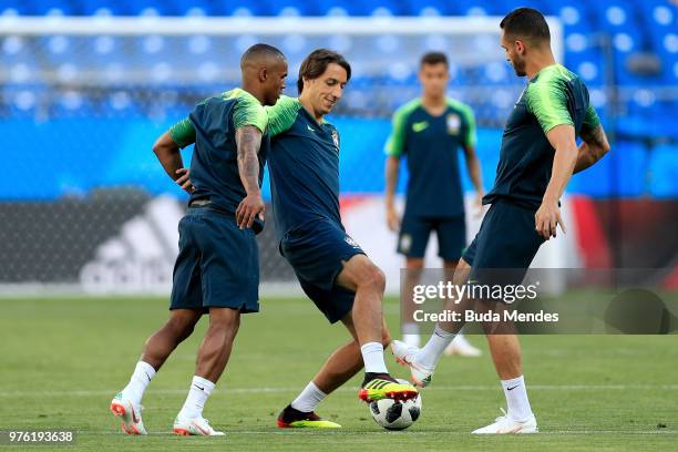 Pedro Geromel, Douglas Costa and Renato Augusto of Brazil take part in a drill during a Brazil training session ahead of the FIFA World Cup 2018 at...