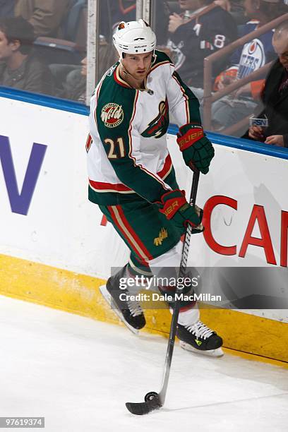 Kyle Brodziak of the Minnesota Wild handles the puck against the Edmonton Oilers on March 5, 2010 at Rexall Place in Edmonton, Alberta, Canada.