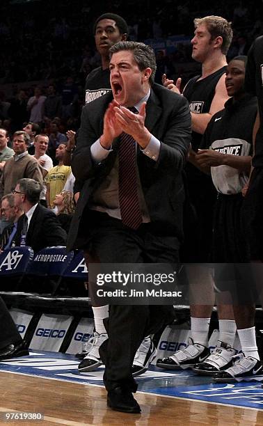 Head coach Keno Davis of the Providence Friars reacts from the bench against the Seton Hall Pirates during the first round game of the Big East...