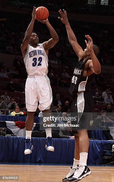 Jeff Robinson of the Seton Hall Pirates shoots the ball against Bilal Dixon of the Providence Friars during the first round game of the Big East...