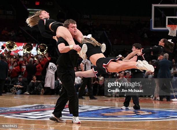 The Cincinnati Bearcats cheerleaders perform on the court against the Rutgers Scarlet Knights during the first round game of the Big East Basketball...