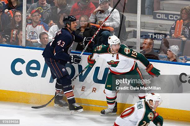 Jason Strudwick of the Edmonton Oilers skates against Andrew Brunette of the Minnesota Wild on March 5, 2010 at Rexall Place in Edmonton, Alberta,...