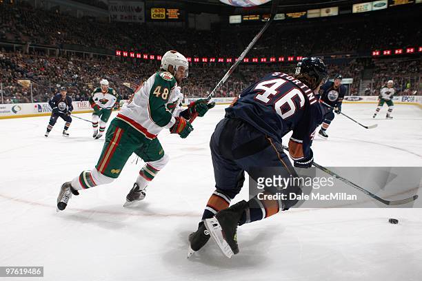 Guillaume Latendresse of the Minnesota Wild skates for the puck against the Edmonton Oilers on March 5, 2010 at Rexall Place in Edmonton, Alberta,...