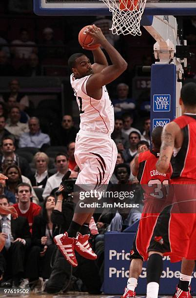 Steve Toyloy of the Cincinnati Bearcats pulls down a rebound against the Rutgers Scarlet Knights during the first round game of the Big East...