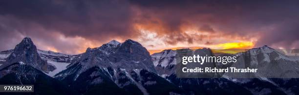 panoramic view of mountain range at sunset, canmore, alberta, canada - thrasher stock pictures, royalty-free photos & images