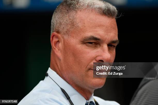 Dayton Moore general manager of the Kansas City Royals watches the batting practice prior to a game against the Cincinnati Reds at Kauffman Stadium...