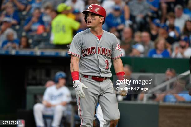 Scooter Gennett of the Cincinnati Reds walks off the field after batting against the Kansas City Royals at Kauffman Stadium on June 12, 2018 in...