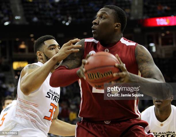 Tiny Gallon of the Oklahoma Sooners looks to shoot over Marshall Moses of the Oklahoma State Cowboys in the first half during the first round game of...