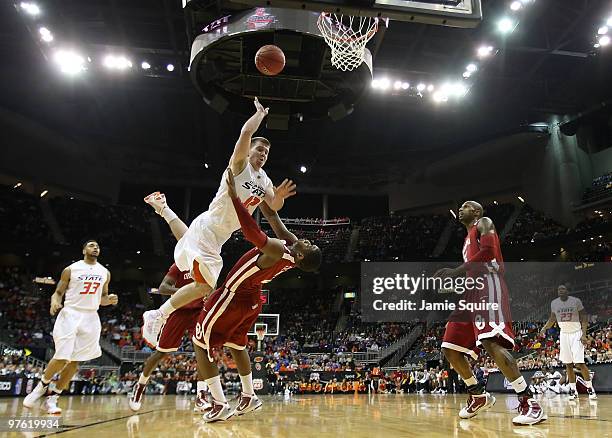 Keiton Page of the Oklahoma State Cowboys goes up for a shot over Steven Pledger of the Oklahoma Sooners during the first round game of the 2010...