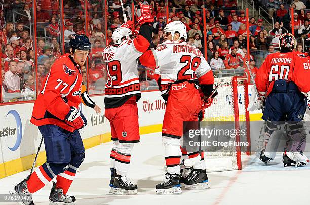 Patrick Dwyer of the Carolina Hurricanes celebrates with Tom Kostopoulos after scoring in the first period against the Washington Capitals on March...