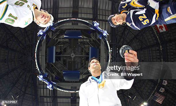 Steve Mesler , a Buffalo native and winner of a gold medal in the four-man bobsled at the 2010 Winter Olympics, drops a ceremonial puck between Craig...