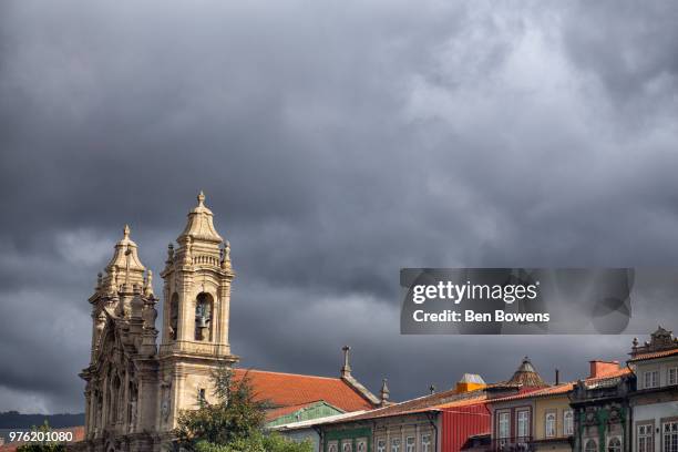 storm clouds over old town, braga, portugal - braga district stock-fotos und bilder