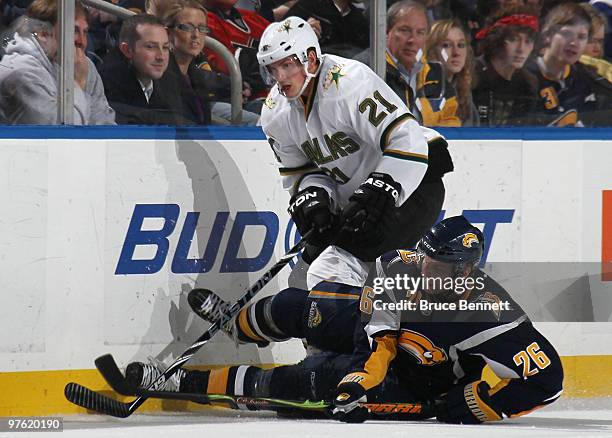 Thomas Vanek of the Buffalo Sabres is knocked down while playing the puck against Loui Eriksson of the Dallas Stars at the HSBC Arena on March 10,...