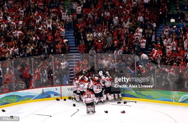 Team Canada celebrate after Sidney Crosby of Canada scored the match-winning goal in overtime during the ice hockey men's gold medal game between USA...