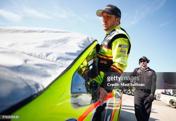 Matt Crafton, driver of the Jack Links/Menards Ford, gets into his truck during practice for the NASCAR Camping World Truck Series M&M's 200 at Iowa...