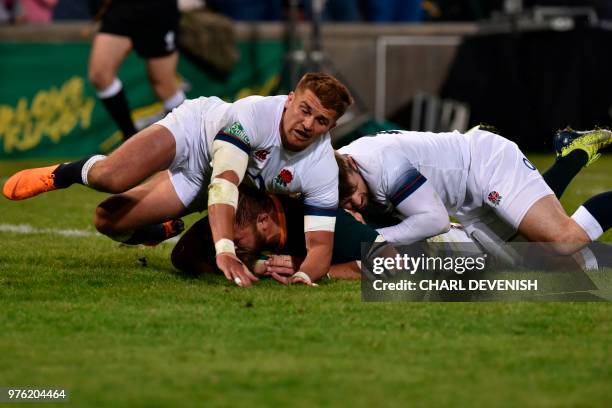 South Africas Duane Vermeulen scores a try despite Englands flyhalf Henry Slade during the second test match South Africa vs England at the Free...