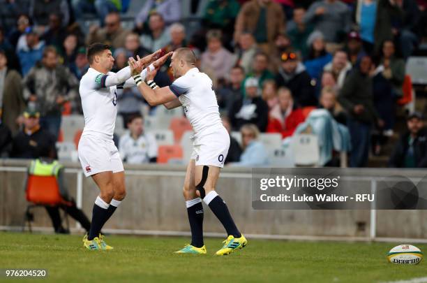 Mike Brown of England is congratulated by teammate Ben Youngs after scoring the opening try during the Rugby Union tour match between South Africa...