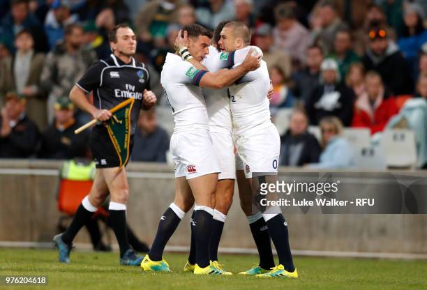 Mike Brown of England is congratulated by teammate George Ford after scoring the opening try during the Rugby Union tour match between South Africa...