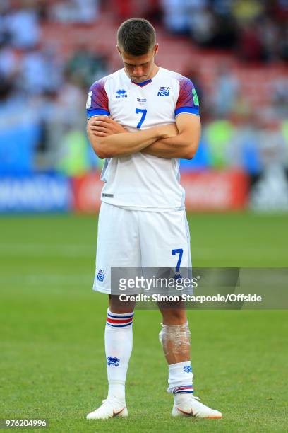 Johann Gudmundsson of Iceland looks dejected as he stands with an ice pack wrapped around his leg after sustaining an injury during the 2018 FIFA...