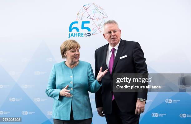 June 2018, Germany, Berlin: German Chancellor Angela Merkel of the Christian Democratic Union is welcomed by Peter Limbourg, director of the Deutsche...
