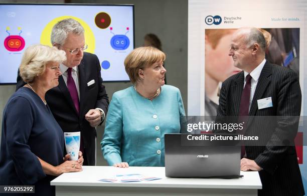 June 2018, Germany, Berlin: German Chancellor Angela Merkel of the Christian Democratic Union informs herself about the work of the channel together...