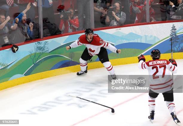 Sidney Crosby of Canada celebrates with teammate Scott Niedermayer after Crosby scored the match-winning goal in overtime during the ice hockey men's...