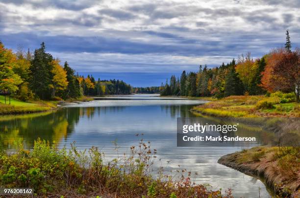 clouds over river in forest, maine, new england, usa - new england   usa stock pictures, royalty-free photos & images