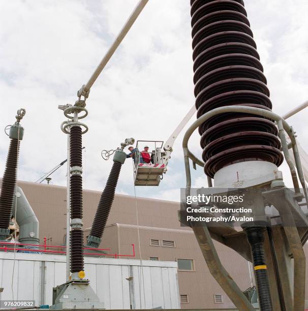 Installing electrical equipment at power station,.