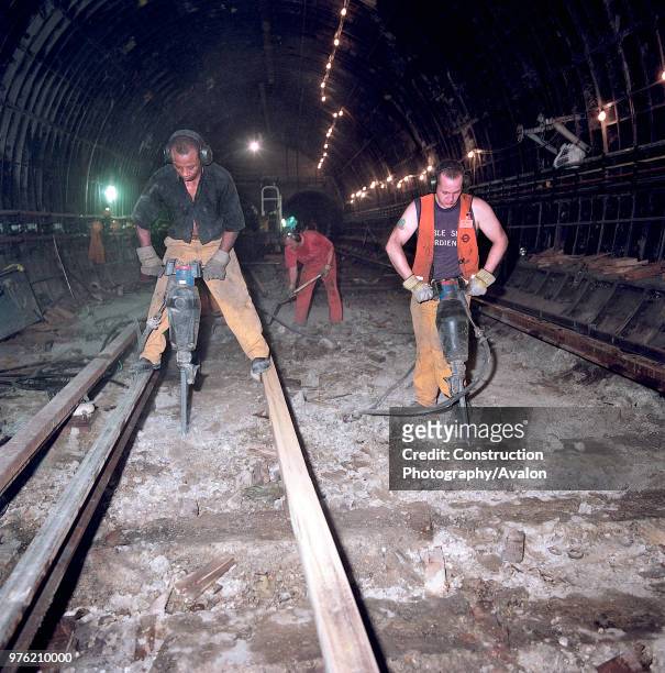 Excavating track bed during refurbishment of Angel Underground station. London, United Kingdom, 27th November 2002.