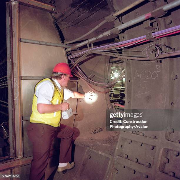 Inspecting tunnel during refurbishment of Angel Underground station, London, United Kingdom,.