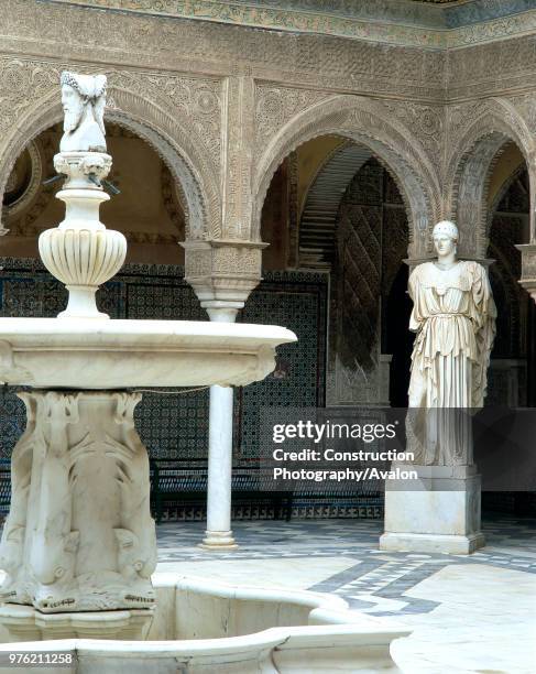 Fountain and statue in a courtyard, casa de pilatos, seville, Spain.