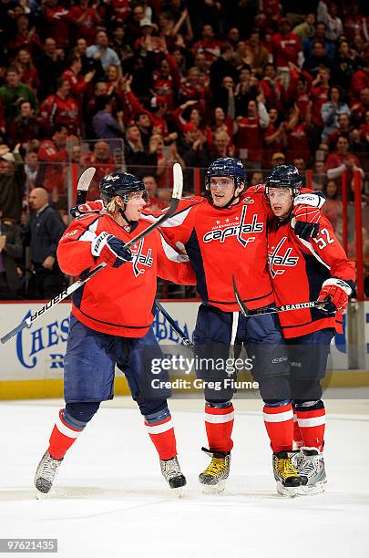 Mike Green of the Washington Capitals celebrates with Alex Ovechkin and Nicklas Backstrom after scoring in the second period against the Carolina...