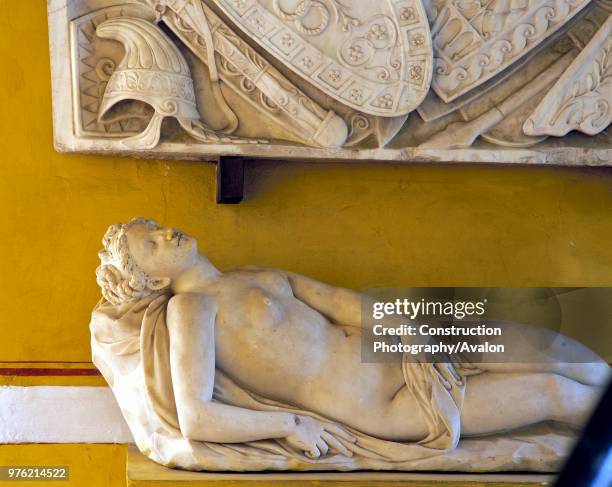 Wall art mounted on wall with naked statue, casa de pilatos, Seville, Spain.