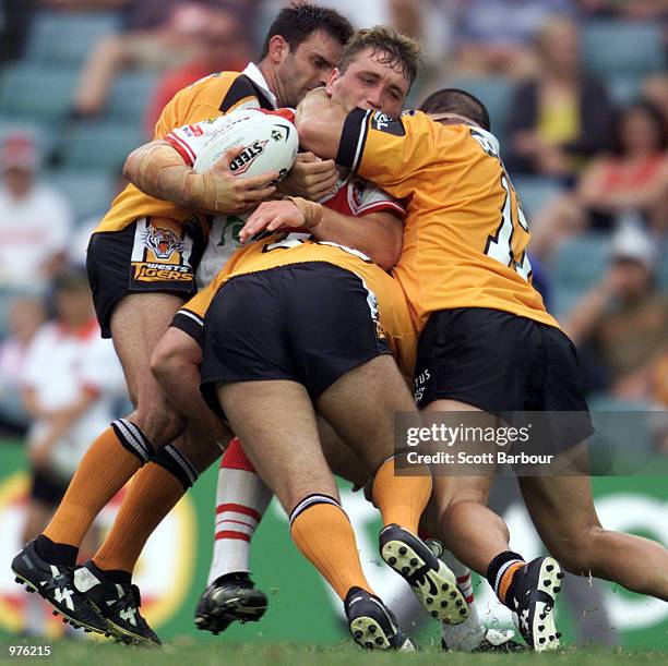 Wayne Bartrim of the Dragons is tackled by the Tigers defence during the round 2 NRL match between the St George Illawarra Dragons and Wests Tigers...