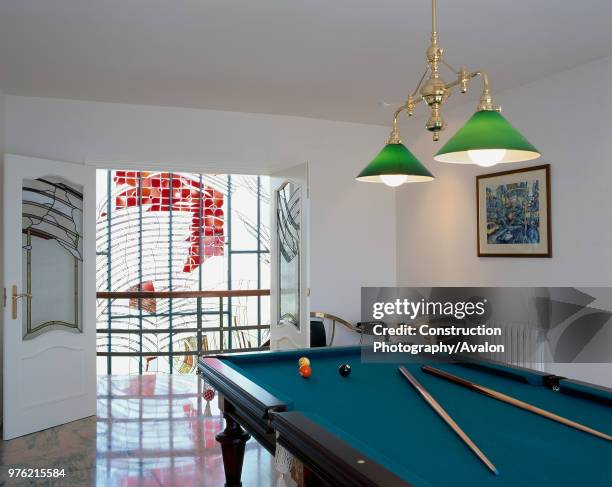 View of a billiards table in a game room.